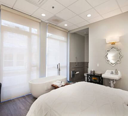 willow midwife center for birth and wellness bedroom, white and elegant bedroom with a bathtub and shower in the room